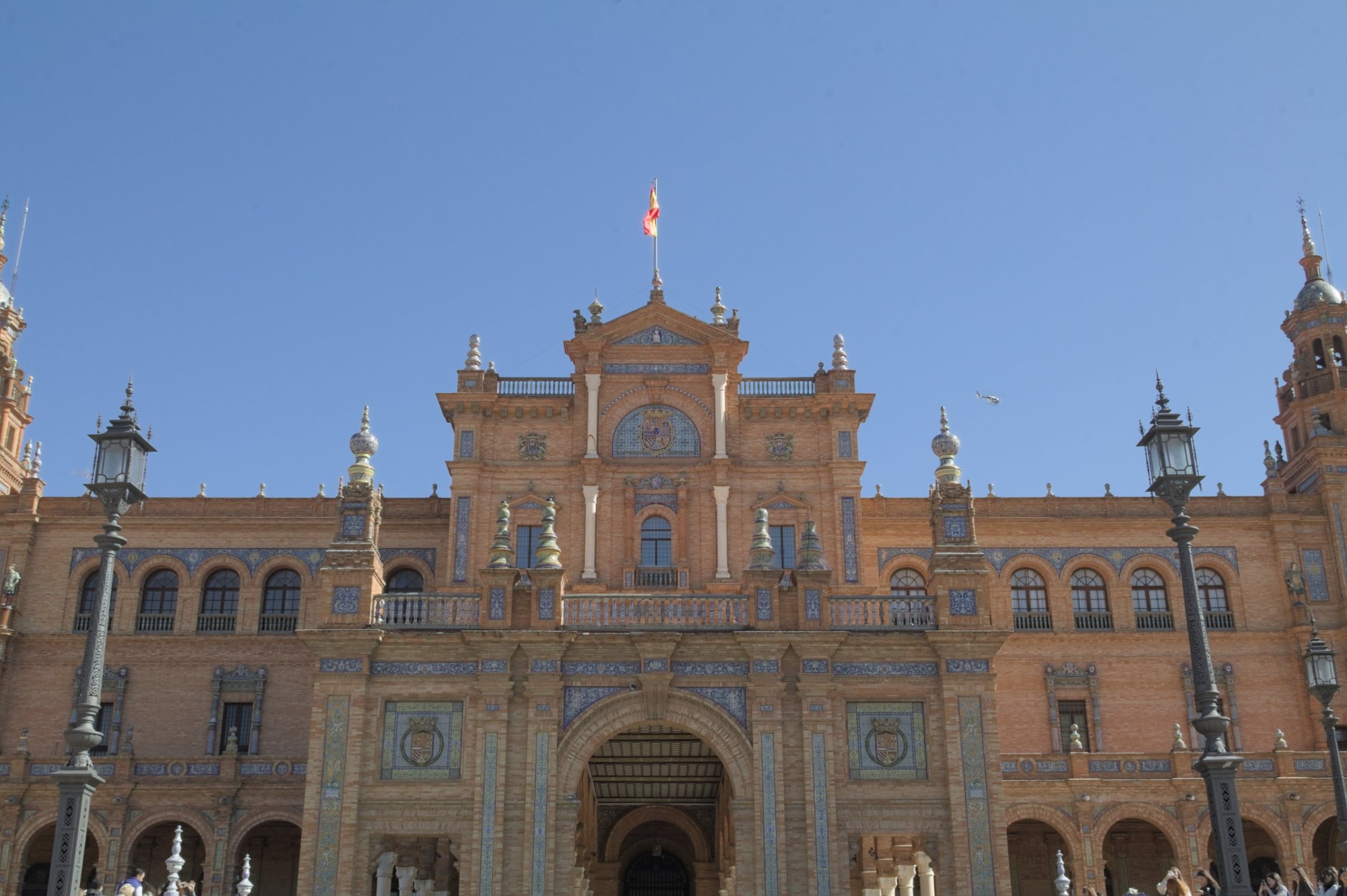 Front facade of the Plaza de Espana in Seville with its central pavilion and ceramic tilework under a clear February sky