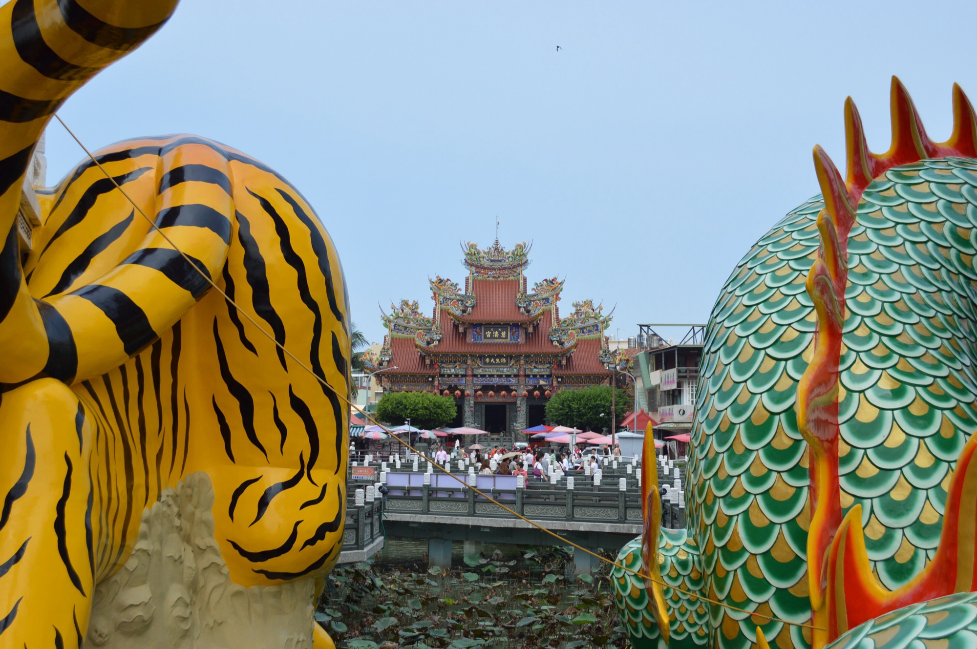 The colourful tiger and dragon sculptures of the Dragon and Tiger Pagodas framing the ornate Cihji Palace across Lotus Pond in Kaohsiung